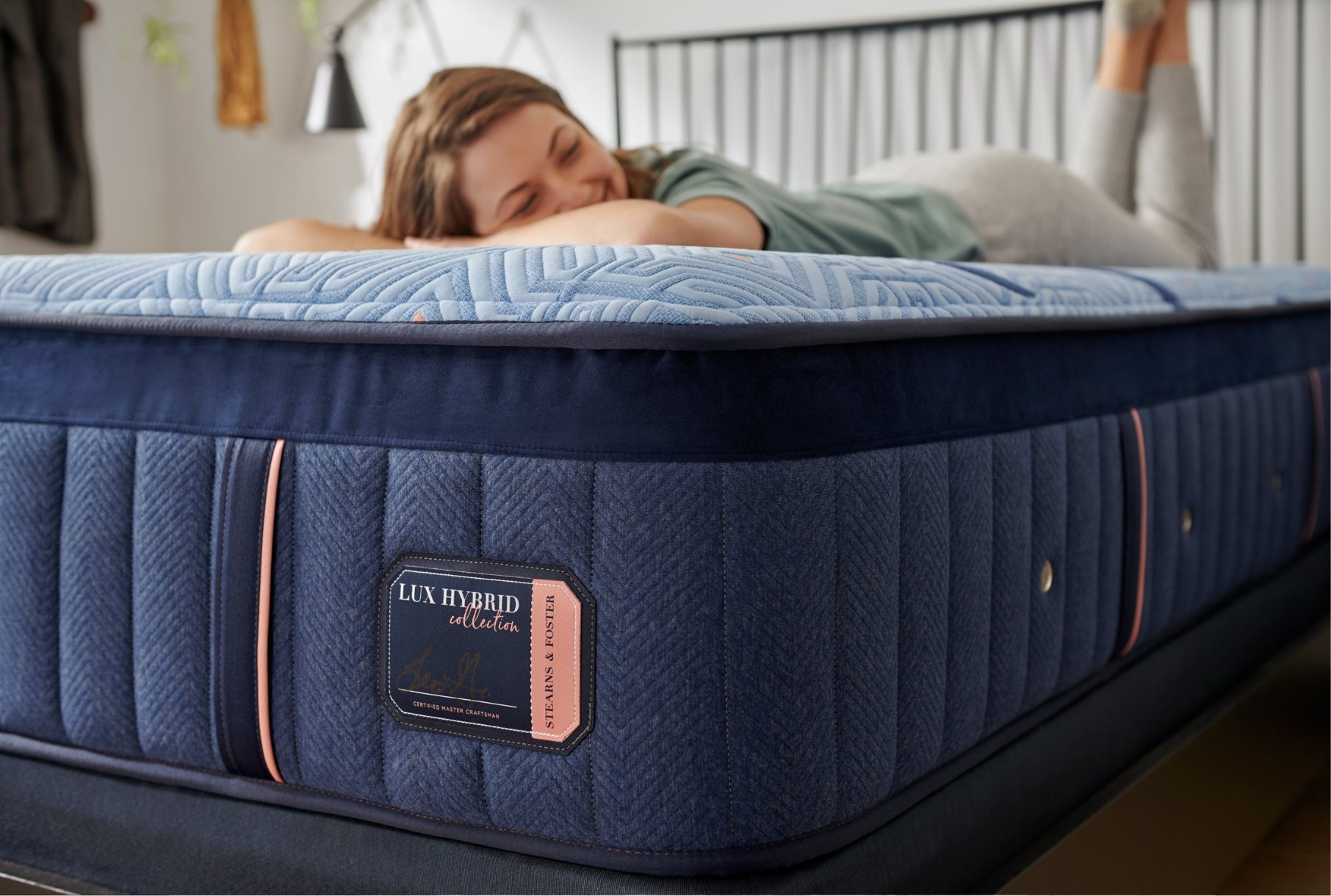 Woman laying on Lux Hybrid mattress